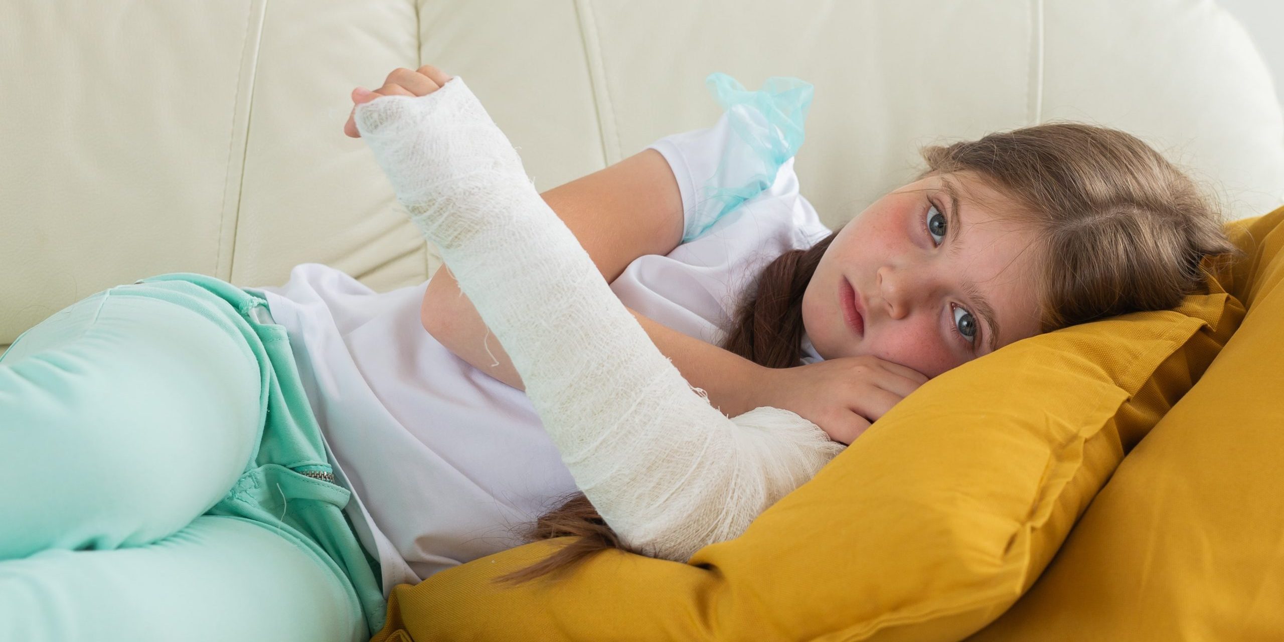 child-with-cast-broken-wrist-arm-lying-couch-recovery-disease-concept-min
