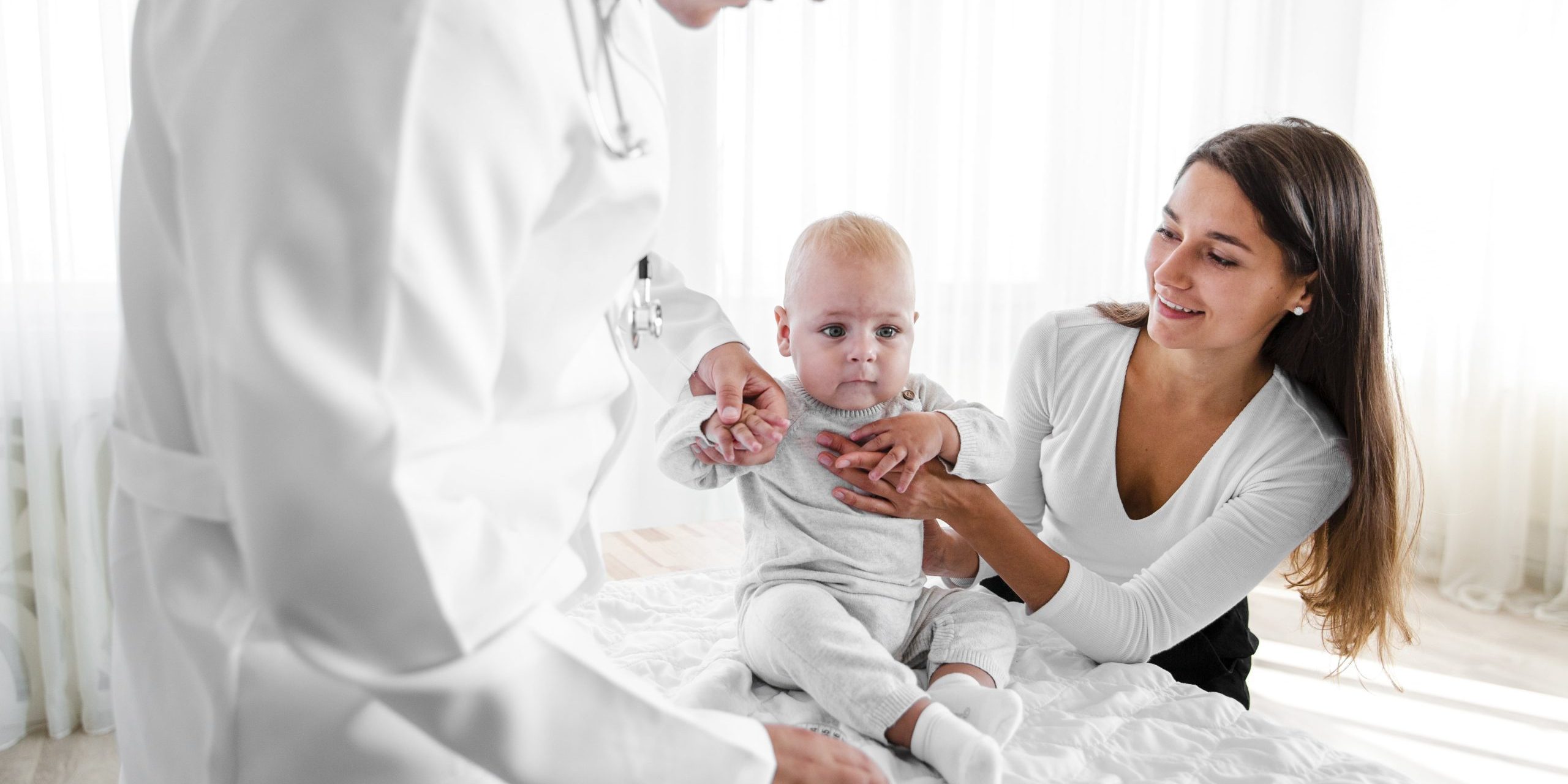 new-born-baby-held-by-doctor-mother-min