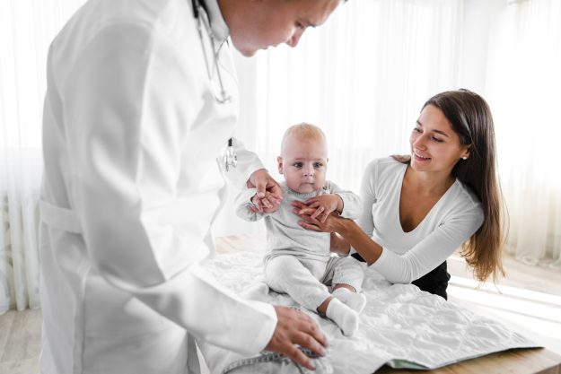 new-born-baby-held-by-doctor-mother-min